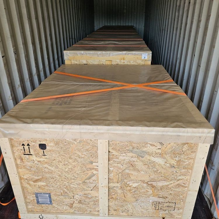Sea container loaded with strapped wooden export crates, ready for ocean freight.